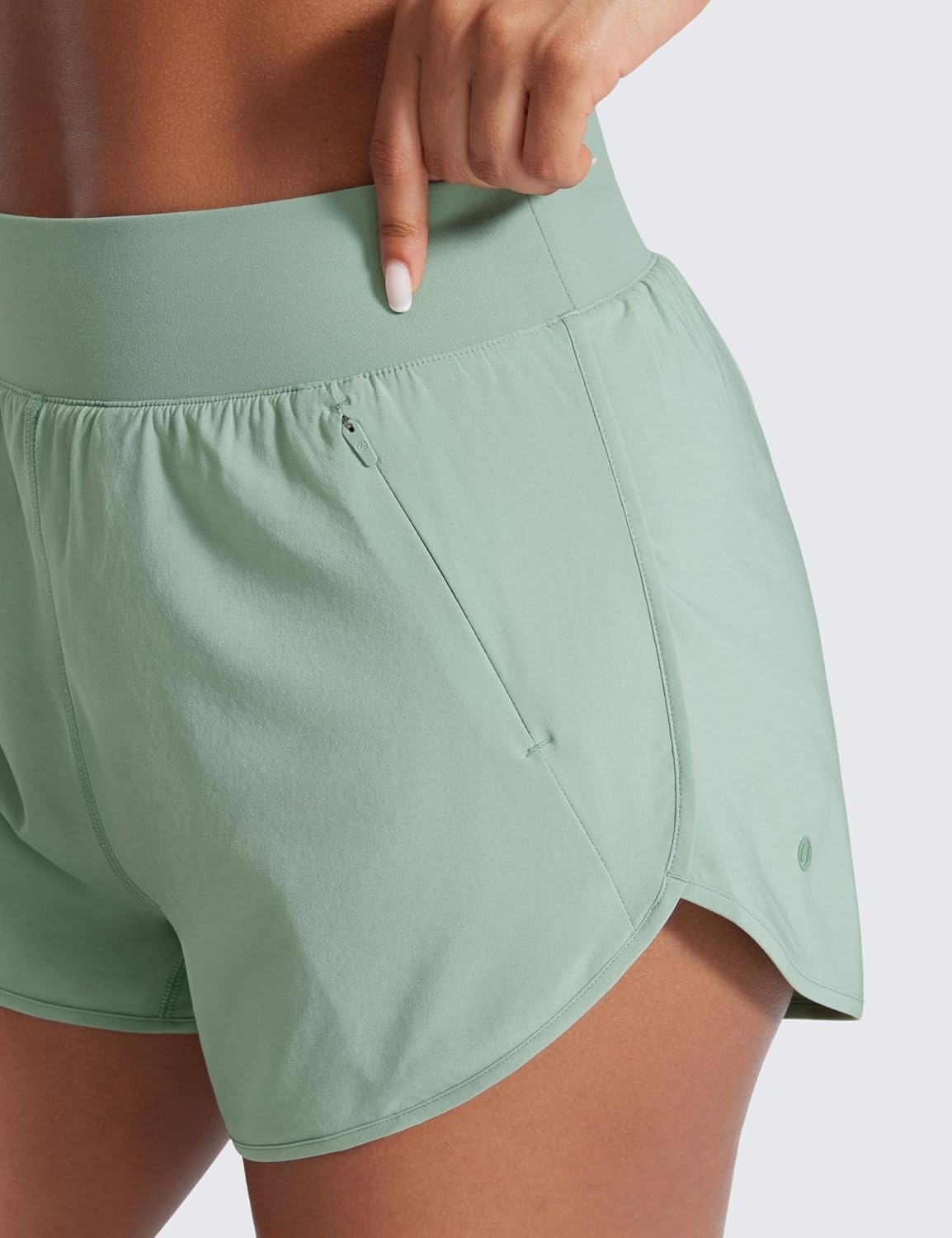 image:imageCRZ YOGA Dolphin Flat Waist Athletic Shorts for Women 3 High Rise Quick Dry for Running Workout Gym Track with Zip PocketsGreen Palm Court
