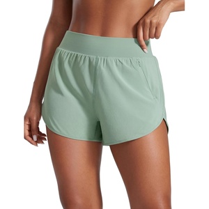 CRZ YOGA Dolphin Flat Waist Athletic Shorts for Women 3″ – High Rise Quick Dry for Running Workout Gym Track with Zip Pockets(Green Palm Court)